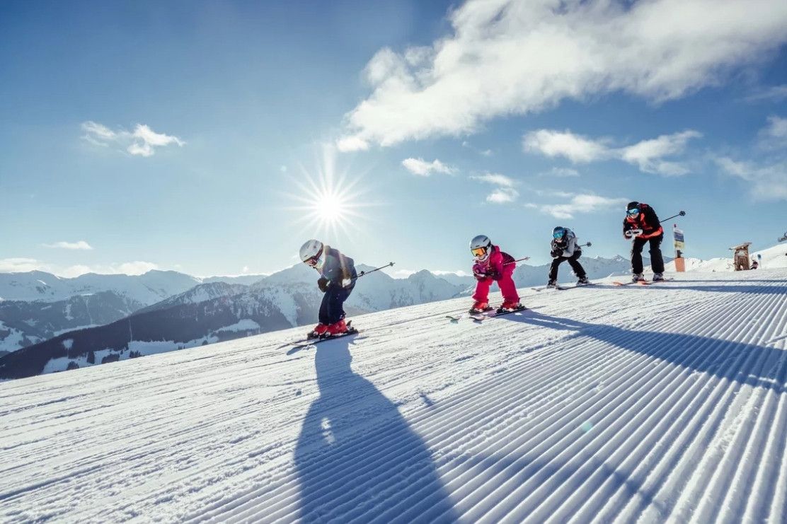 Family Skiing on bluebird day in the ski juwel region