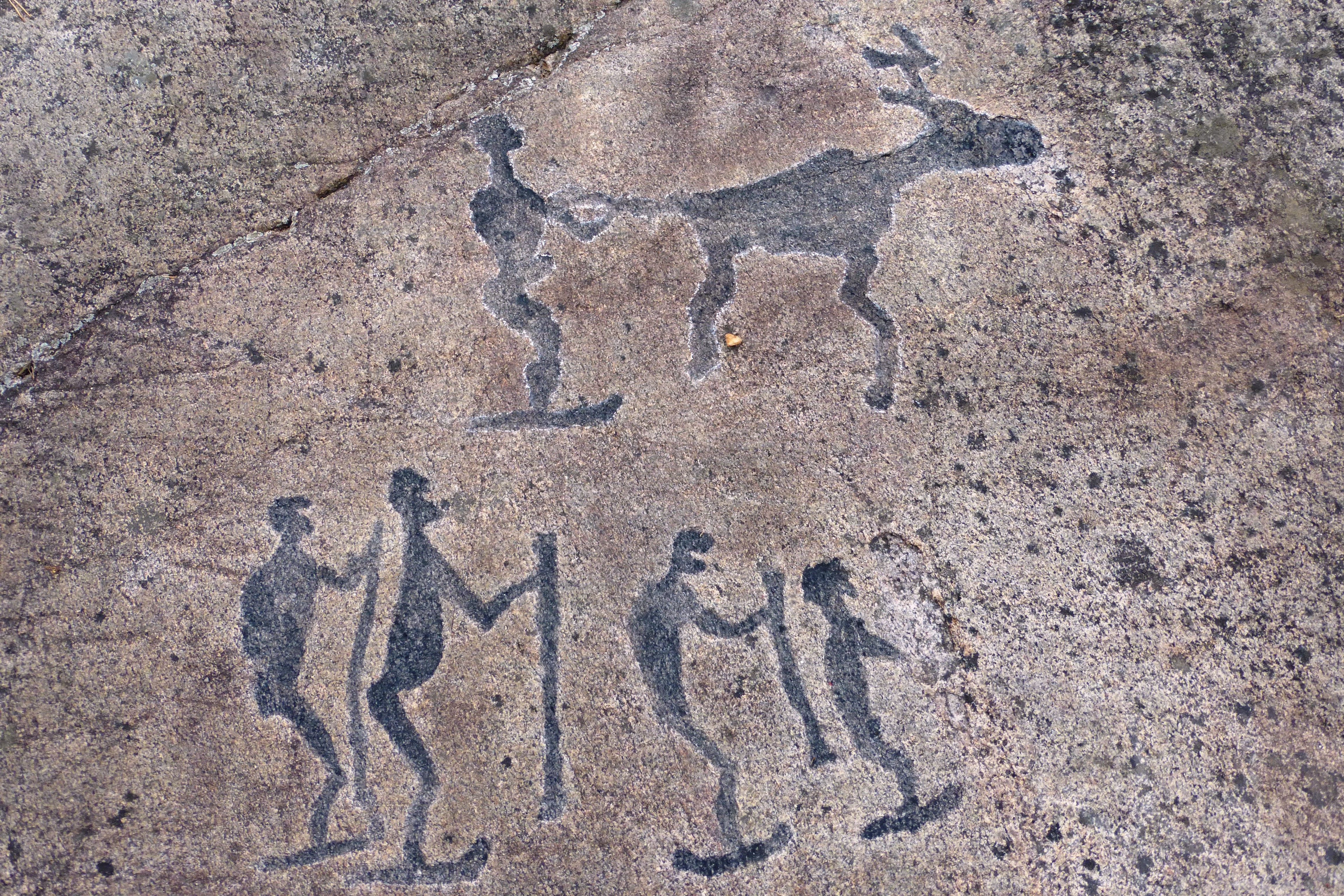 early carvings dipicting skiers
